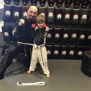 Martial arts instructor and a boy with raised fists at Tiger Shulmann's in Princeton