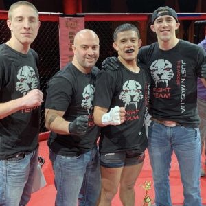 MMA fighter Justin Muslija with his Tiger Shulmann's crew in octagon