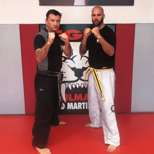 Two martial arts instructors with fists up at Tiger Schulmann's in Red Bank