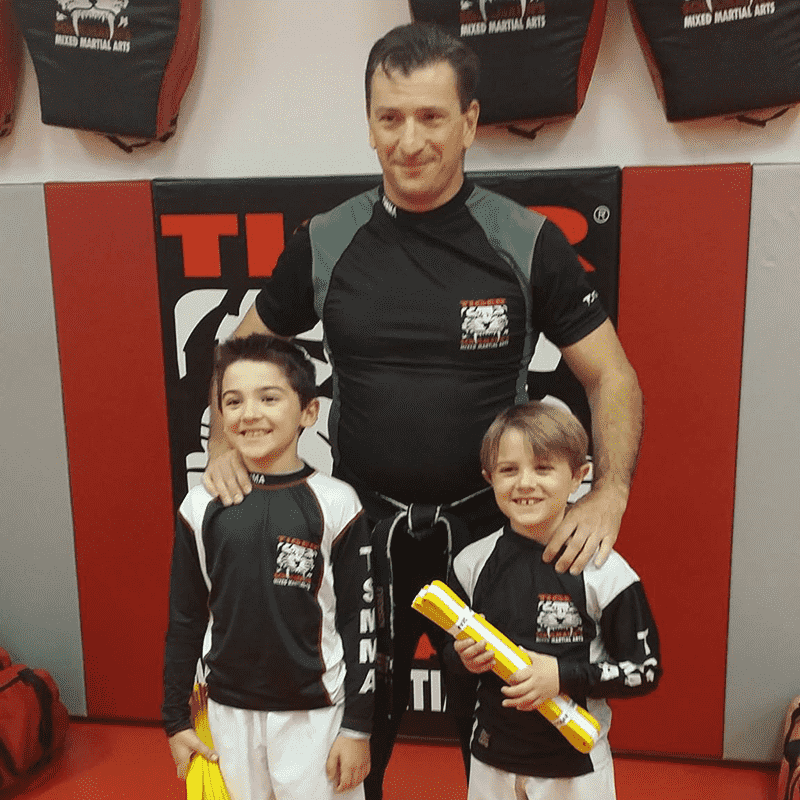 Martial arts instructor with two boys at Tiger Schulmann's in Red Bank