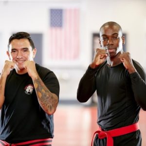 Two men posing in a boxing stance in Bellerose gym