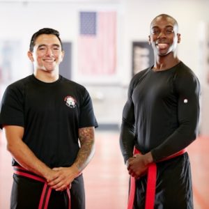 Two men posing in Bellerose gym