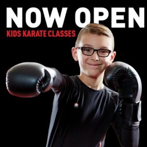 Boy with gloves smiling while doing karate