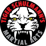 Tiger Schulmann's martial arts logo with a white tiger head