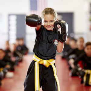 Little girl with fists up as a part of anti-bullying campaign at Tiger Schulmann's