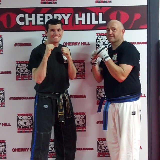 Michael Hess after beating diabetes posing with Sensei Baker at Tiger Schulmann's Ramsey