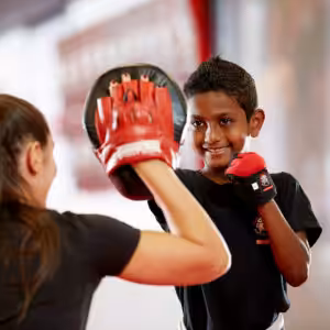 A boy sparring with his Instructor during kids karate class at Tiger Schulmann's