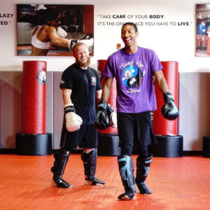 Two martial arts fighters smiling at Tiger Schulmann's Eatontown