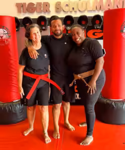 Martial arts instructor with two woman with red belts at Tiger Schulmann's Eatontown