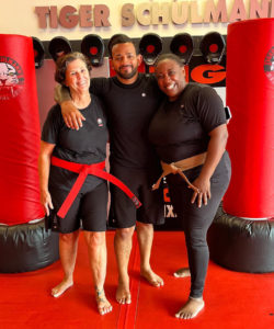 Martial arts instructor with two woman with red belts at Tiger Schulmann's Eatontown