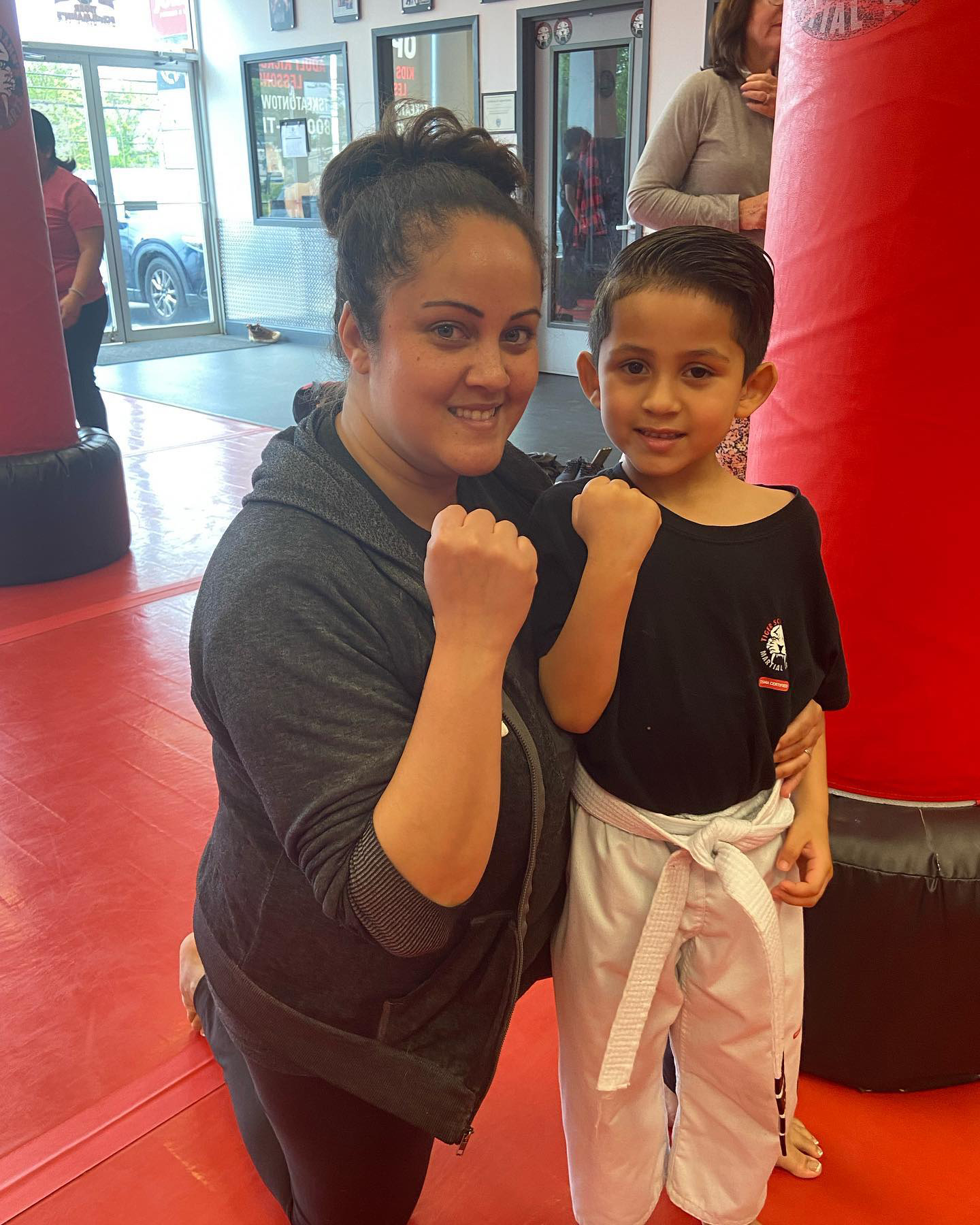 A woman and a little boy with clinched fists during martial arts training at Tiger Schulmann's Eatontown