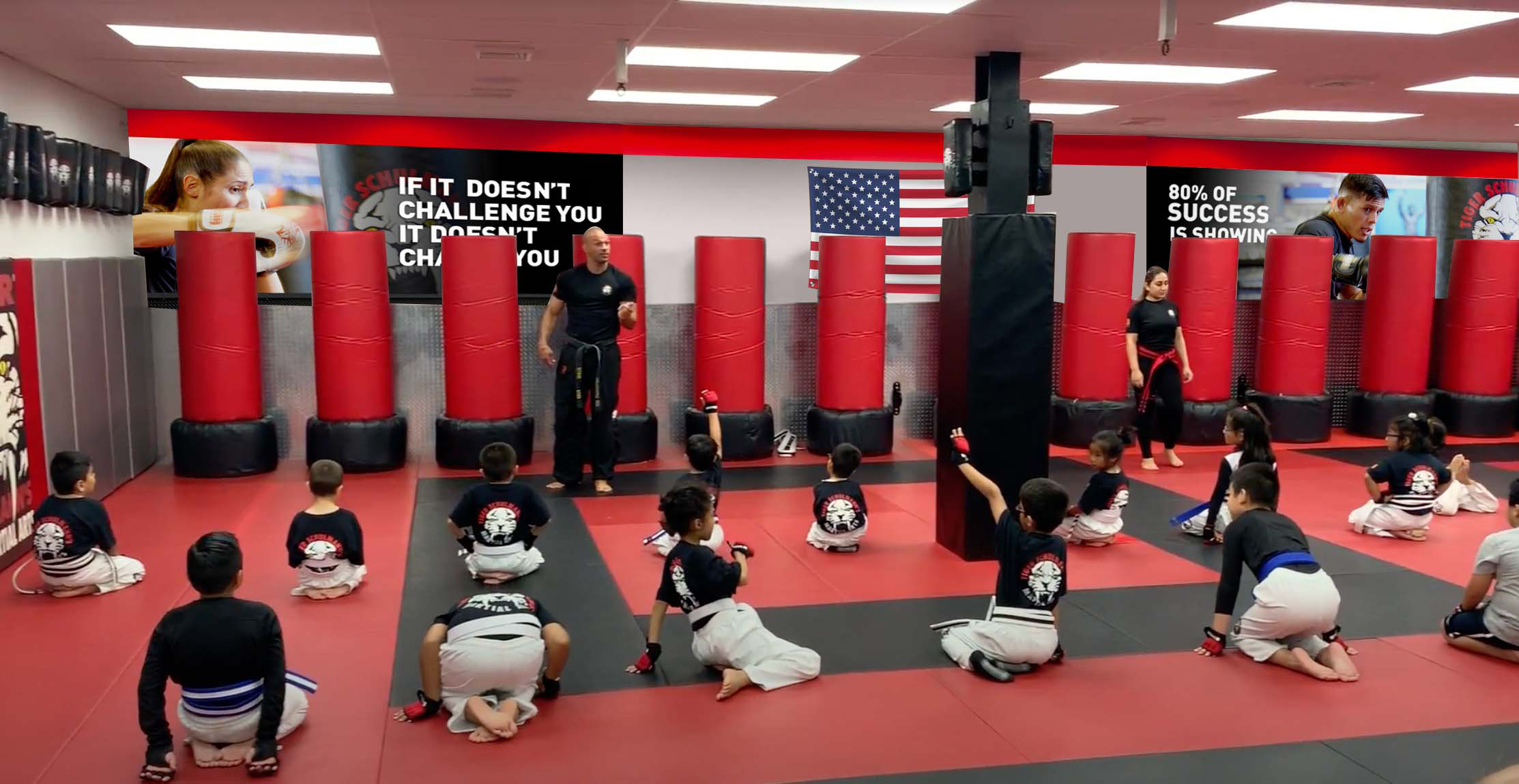 Kids training in front of the Wall with American flags and motivational quotes at Tiger Schulmann's Colmar