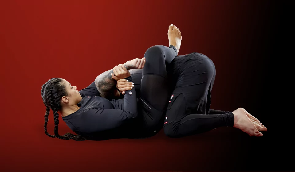 Jiu Jitsu sparing in which women is performing arm lock on a man at TSK