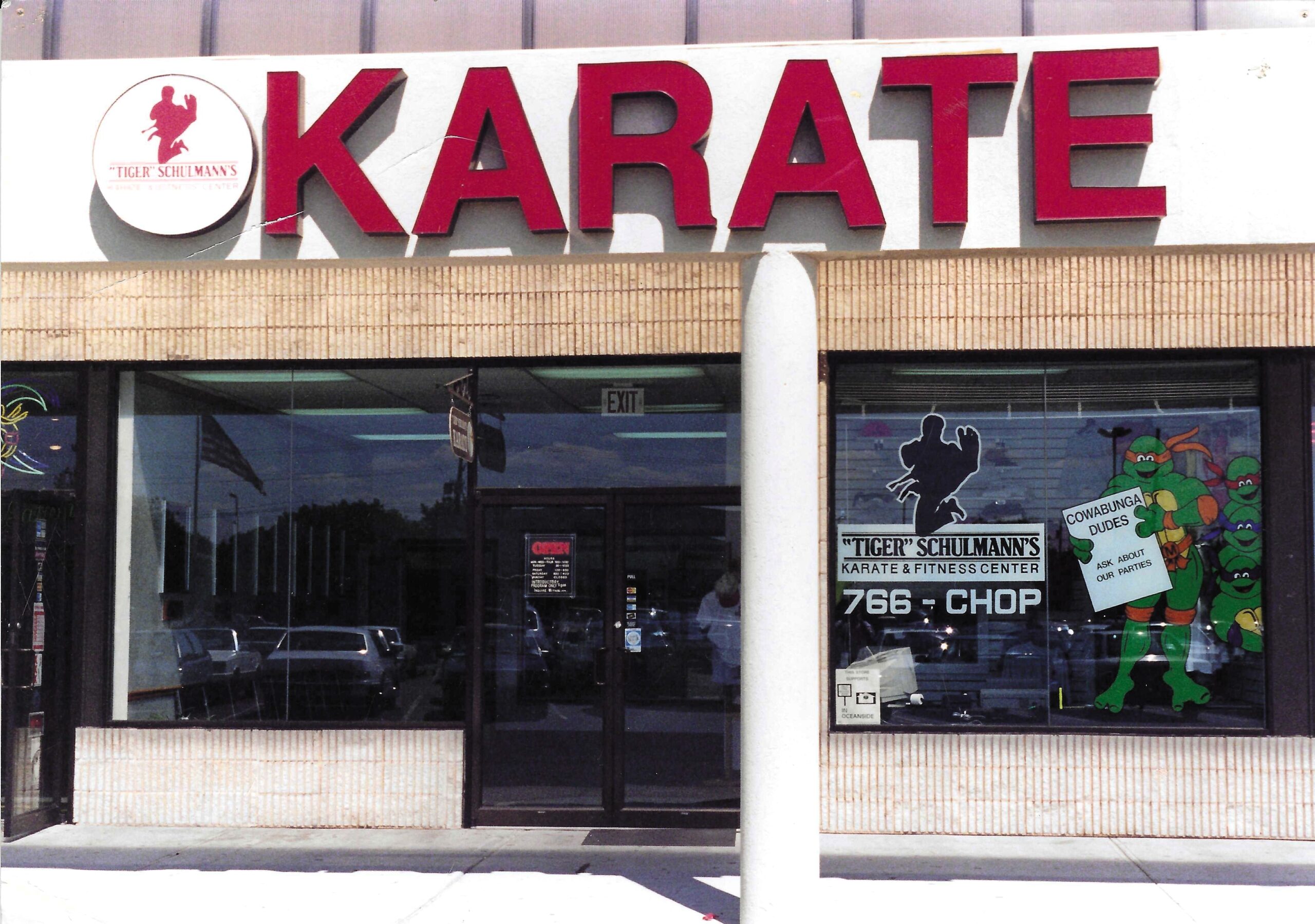 Front view of a TSK karate school. They have a drawing of the ninja turtles to the right.