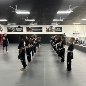 Kids lined up listening to the instructor during the kids kickboxing training at Tiger Shulmann's Horsham, PA