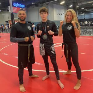 Young TSMA Horsham Kickboxing Student with His two instructors